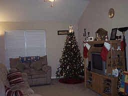 Spacious open living area with high ceiling.