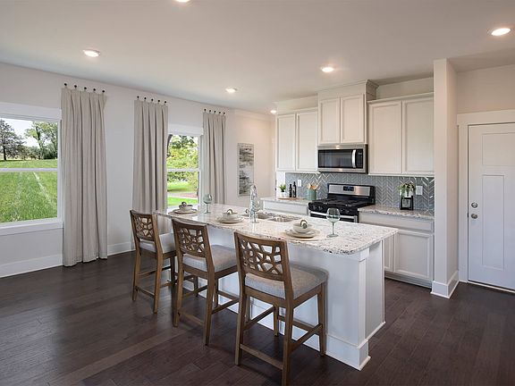 Prep dinner in the kitchen while entertaining in the great room. Photography from Echo Ridge.