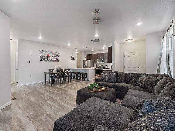 s you enter the foyer, you're welcomed into the inviting living room _ a comfortable and open space perfect for relaxing or entertaining.