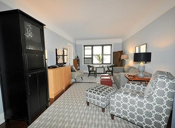 The living room and dining foyer have been opened to create a massive space.  The living room has a cove ceiling, picture molding and refinished hardwood floors.  The living room is 23'-6"  x 12'-6" and the dining foyer is 15'-0" x 8'-0".