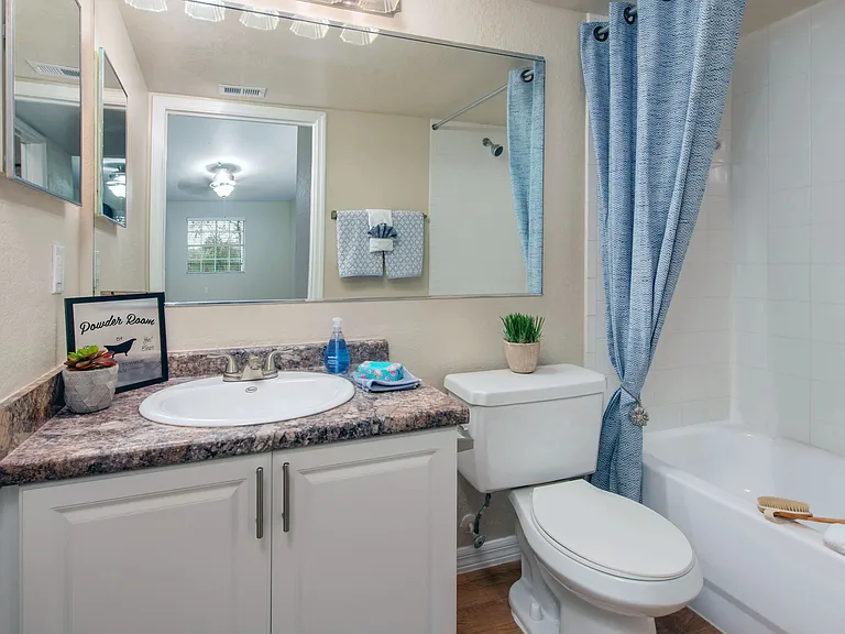 Indulge in luxurious master bathrooms adorned with granite-style counters and expansive mirrors for a touch of modern sophistication.