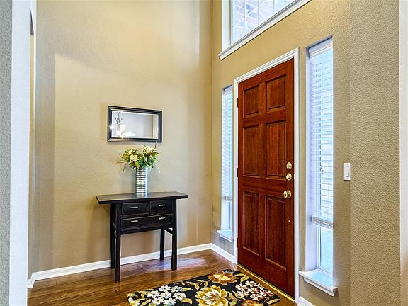 Natural light streams through the full-length and overhead doorway windows
