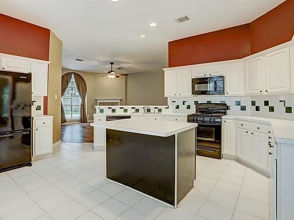 **BEFORE PHOTO** Large, Open Kitchen with Island and plenty of natural light.
