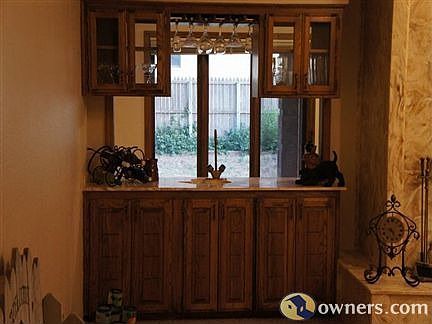 Wet bar in living room w/ access to sunroom