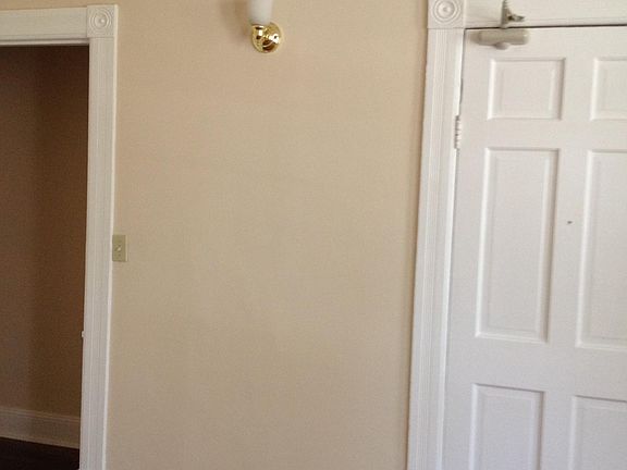 Living room. Door is entrance. Opening is to hall connecting to the 2 bedrooms, bathroom, kitchen, and a door with lock to basement.
