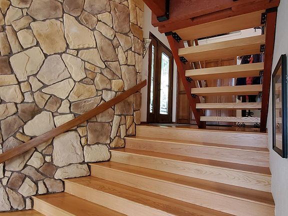 Gorgeous oak entry way with a floating stair case to the upper level.