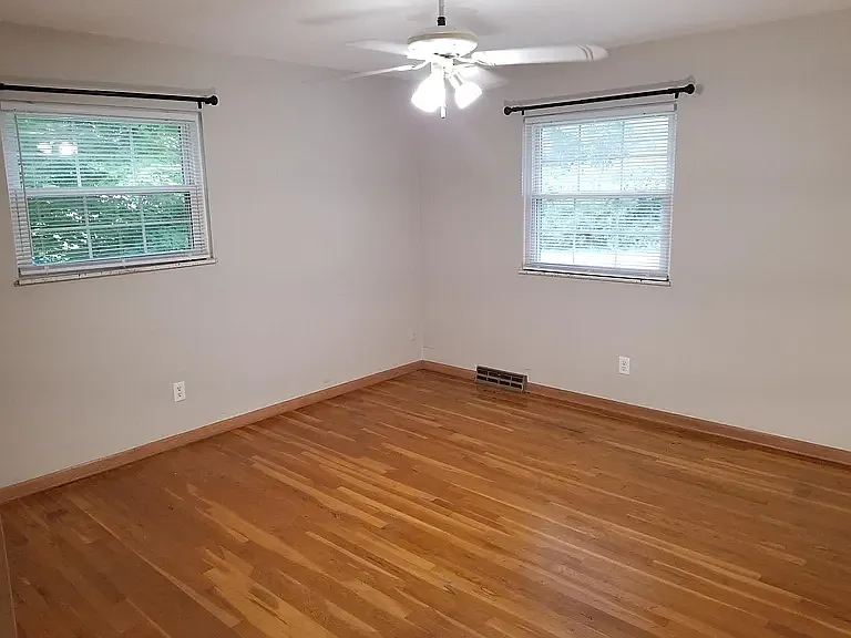 bedroom with fan and large closets