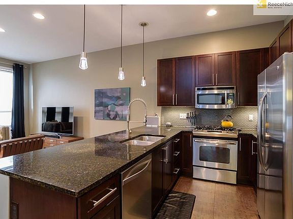 Kitchen boasts updated backsplash, granite countertops & stainless steel appliances