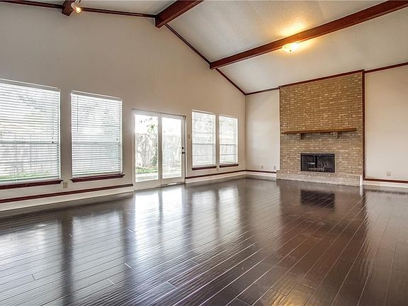 Huge living area with fireplace and soaring beamed ceiling.