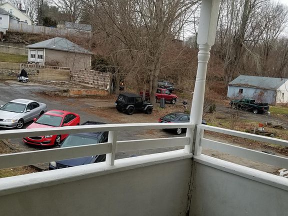 Porch out back door, off street parking in lot pictured.