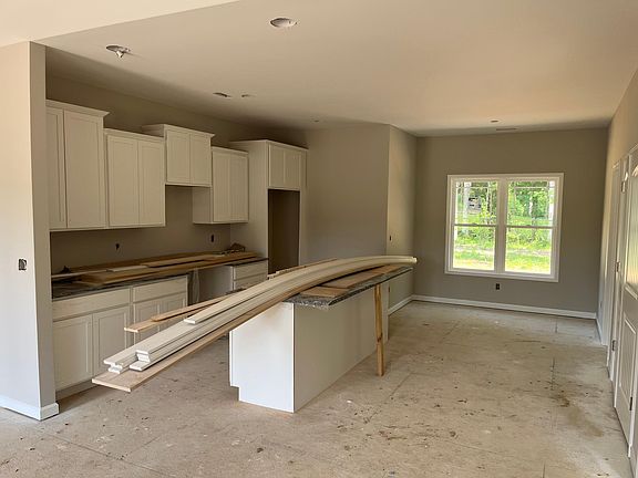 Wood cabinets and stand alone island with granite countertops.