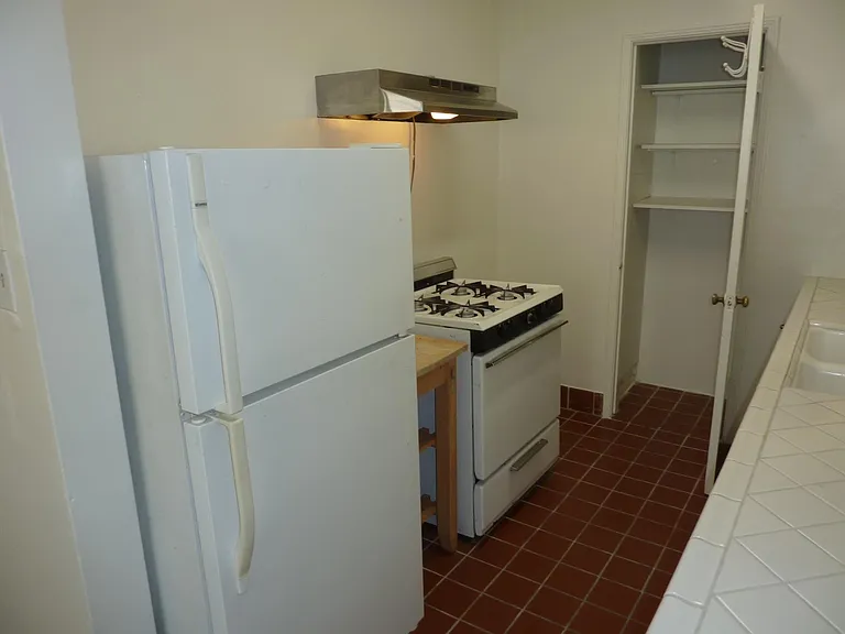 Cozy kitchen with pantry closet.