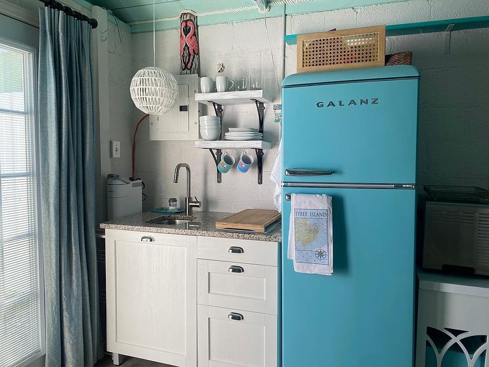 Cute kitchenette with sink, convection cooktop, full fridge coffee maker and microwave