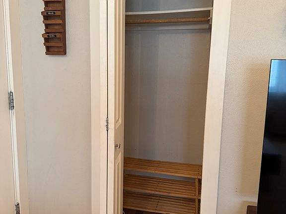 Front storage / coat closet with shoe rack.