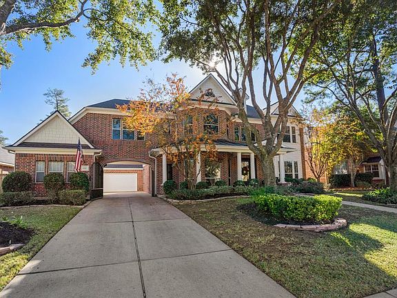 Beautiful front elevation with private gated driveway and gorgeous landscaping.