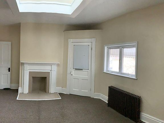 Bedroom 1- large room and closet. Skylight and decorative fireplace.
