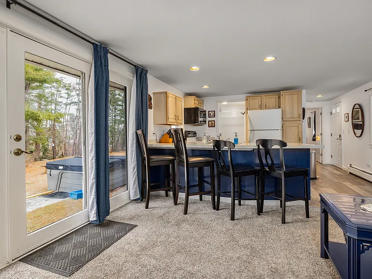 living room and kitchen with views of backyard.