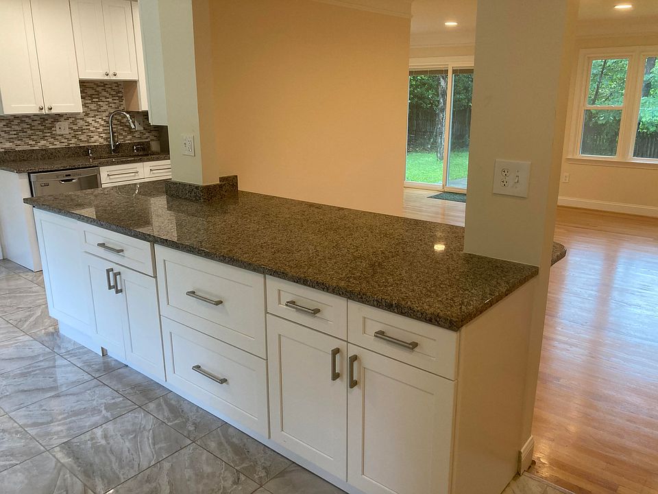 Front entrance to large kitchen wrap around peninsula with bar seating area.