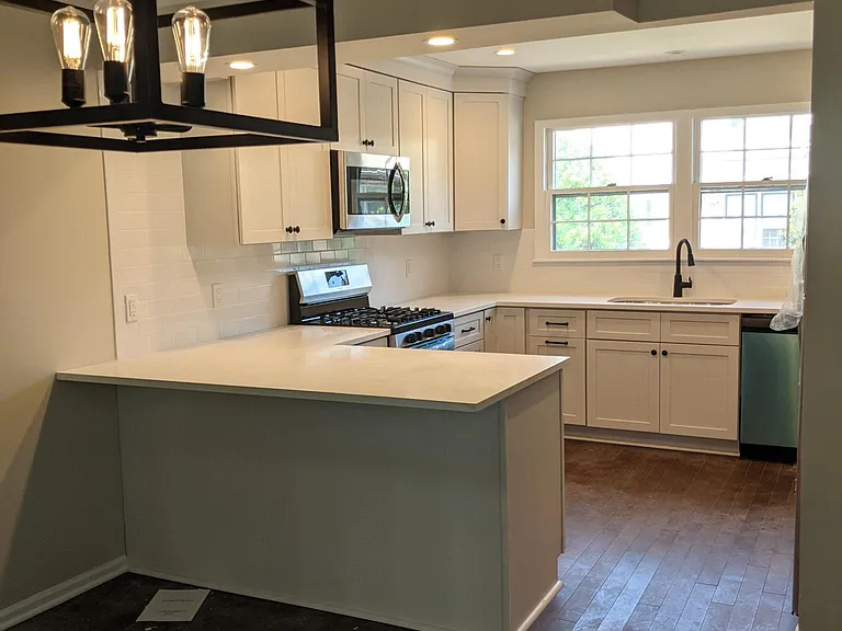 Kitchen with bar-top seating, open to dining room