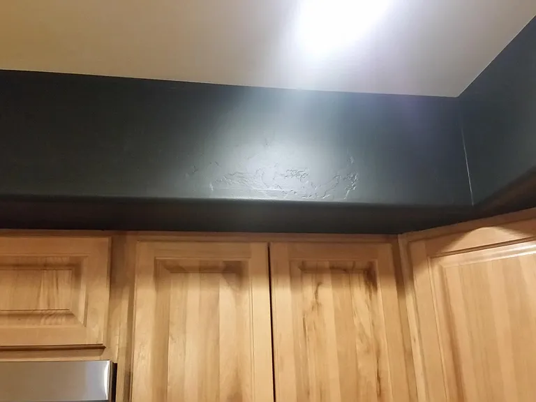 Chalk board over kitchen cabinets