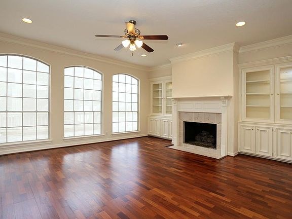 Fireplace in Living Room is Framed by Custom Built Lighted Cabinets