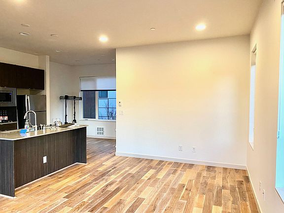 Living area facing the kitchen and dining area.