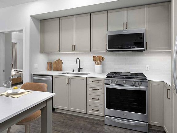 Building B Avalon Design Upgraded kitchen with quartz countertops, backsplash, stainless steel appliances and island