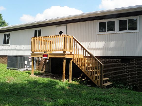 Front of home with small porch and stairs