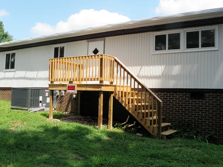 Front of home with small porch and stairs