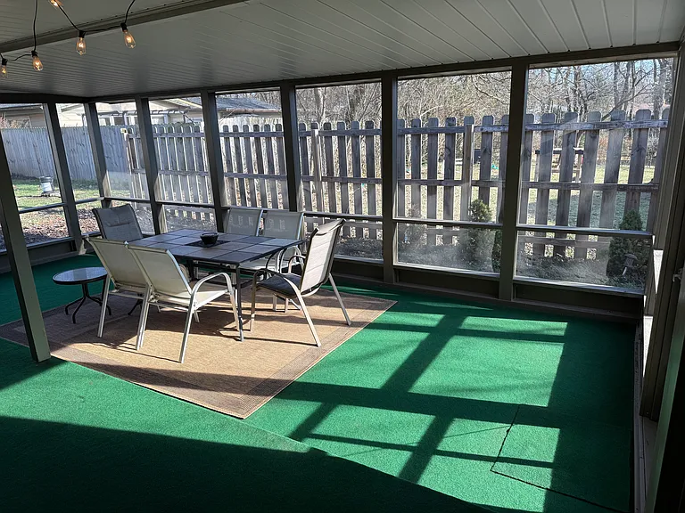 Screened porch right of off dinning area