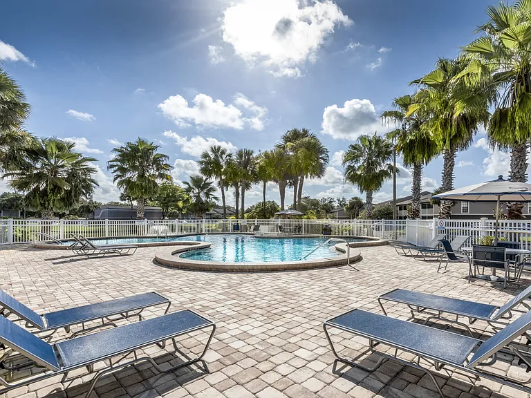 Sun-drenched poolside relaxation under swaying palms