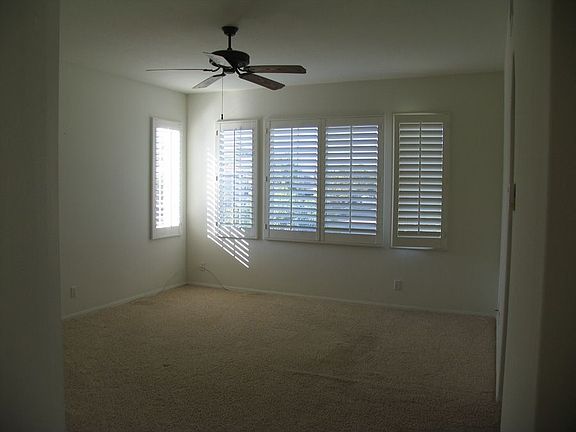 Master bedroom with ceiling fan, plantation shutters and huge walk in closet