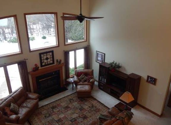 Upper view of Great room with magnificent windows, ceiling fan and view of the backyard