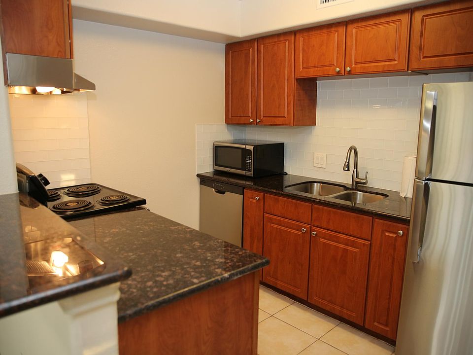 Kitchen with Stainless Steel Appliances, granite countertops, subway tile backsplash and Microwave included.
