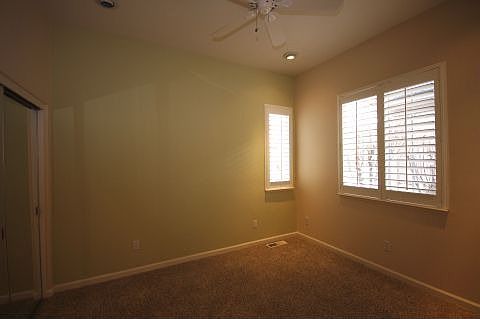 Guest Bedroom (upstairs) has mirrored closet doors &amp; fan.