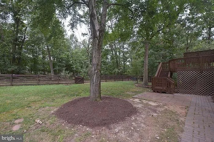 Enjoy large fenced backyard, backing to woods & lots of privacy.