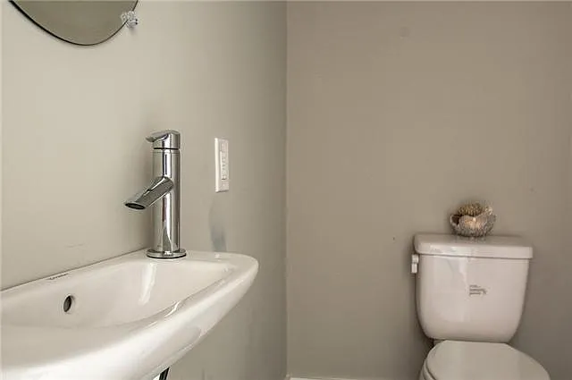 Half bath just off of the kitchen with a custom built vanity (not pictured)