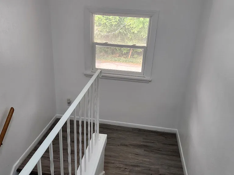 Rear entrance stairway, view looking down from unit 3 and unit 4 landing