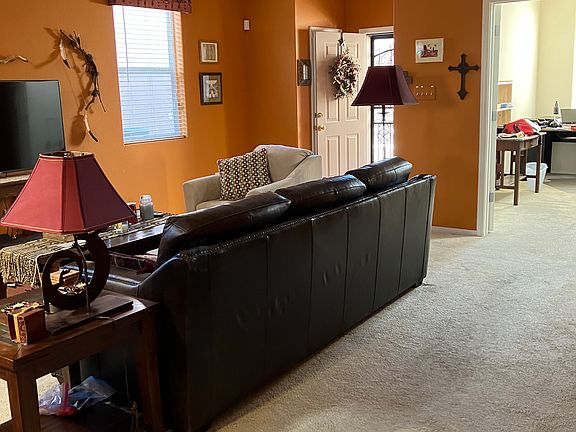 Living room with doorway and view of office area