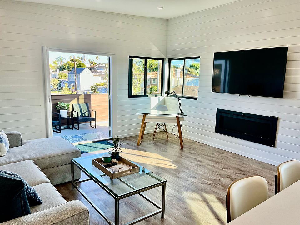 65" smart-tv has all the streaming apps. Below is an electric fireplace that can be light with or without heat.