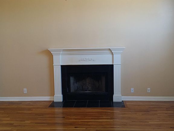 Living room with hardwood floors and wood burning fireplace!