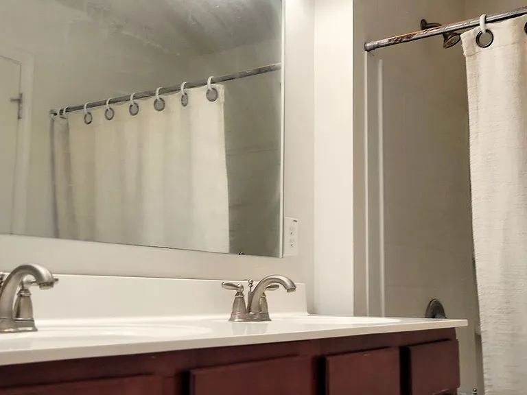 A spacious bathroom offers a refreshing escape from tiredness.