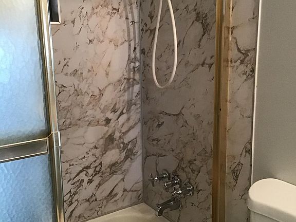 Rear bath with tube and shower