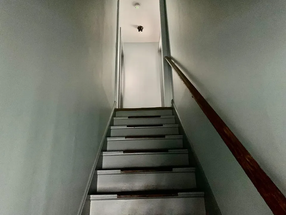 Interior stairs. Rental unit is on the left.