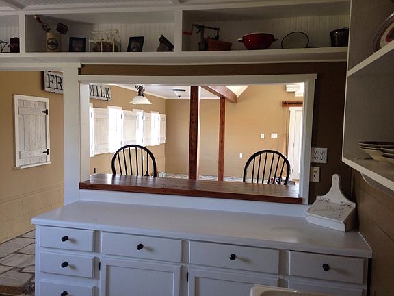 Kitchen has plenty of open & closed cabinets.
