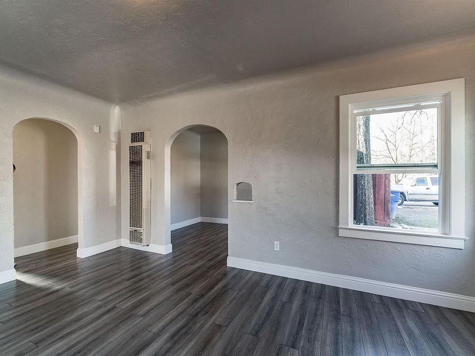 Living room and dining room through the archway on the right
