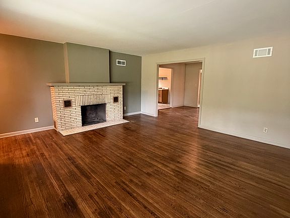 Large living room with wood burning fireplace.