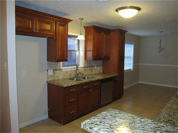 VIEW OF KITCHEN AND BREAKFAST, NEW GRANITE COUNTERS, AND CUSTOM CABINETS