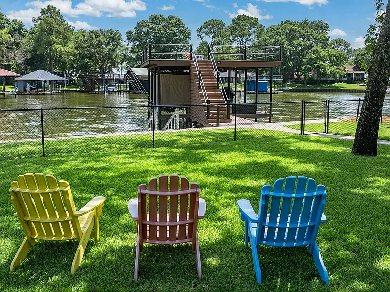 Backyard with covered patio and plenty of seating. With Access to lake and boat dock.