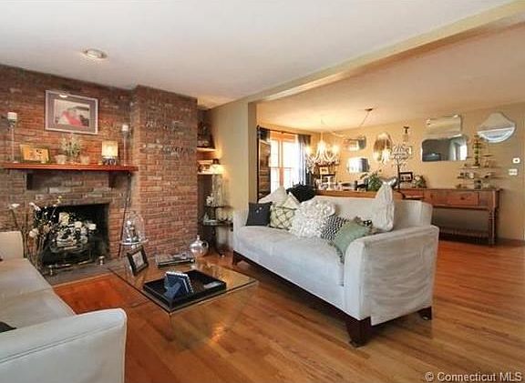 Come home to this every day.  Beautiful floor to ceiling brick fireplace with custom, cherry mantle and custom marble shelves.  Notice all of the natural light coming through dining room and kitchen windows!!